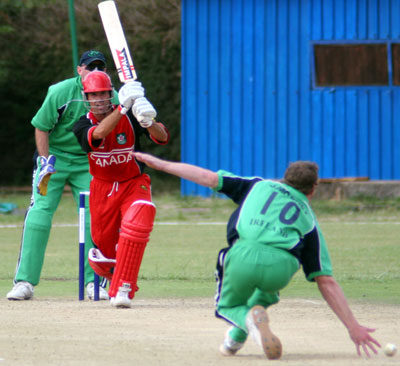 John Davison's drive is well stopped by John Mooney (©CricketEurope)
