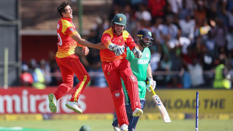 Graeme Cremer and Brendan Taylor celebrate the wicket of Paul Stirling (©ICC)